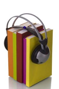 Five books held together with headphones on top